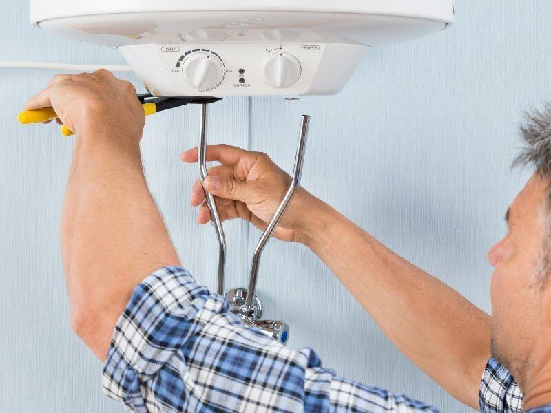 Plumber fixing pipe John G. Plumbing Drain and Sewer Cleaning