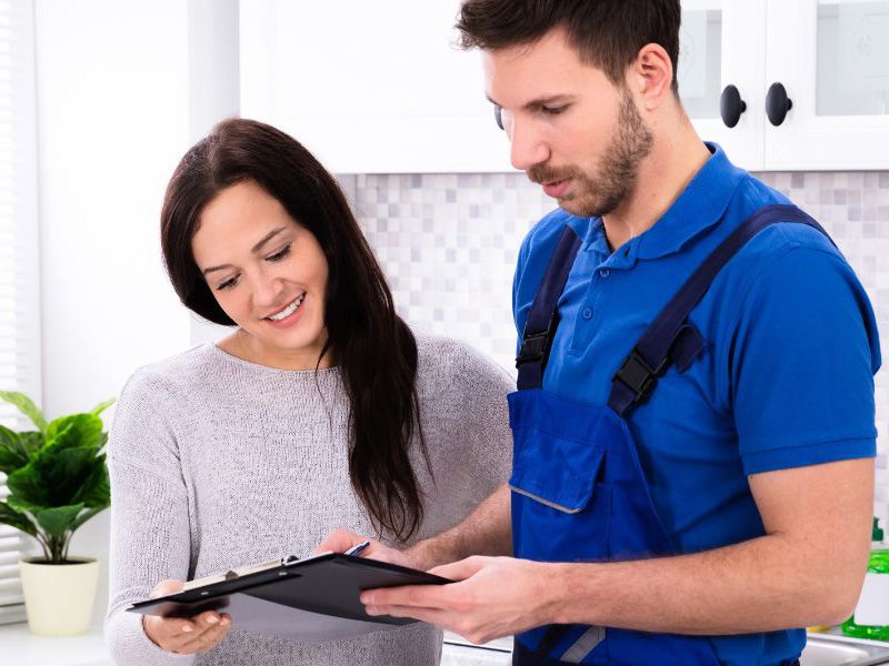 Plumber with client John G. Plumbing Current Promotions and Rebates