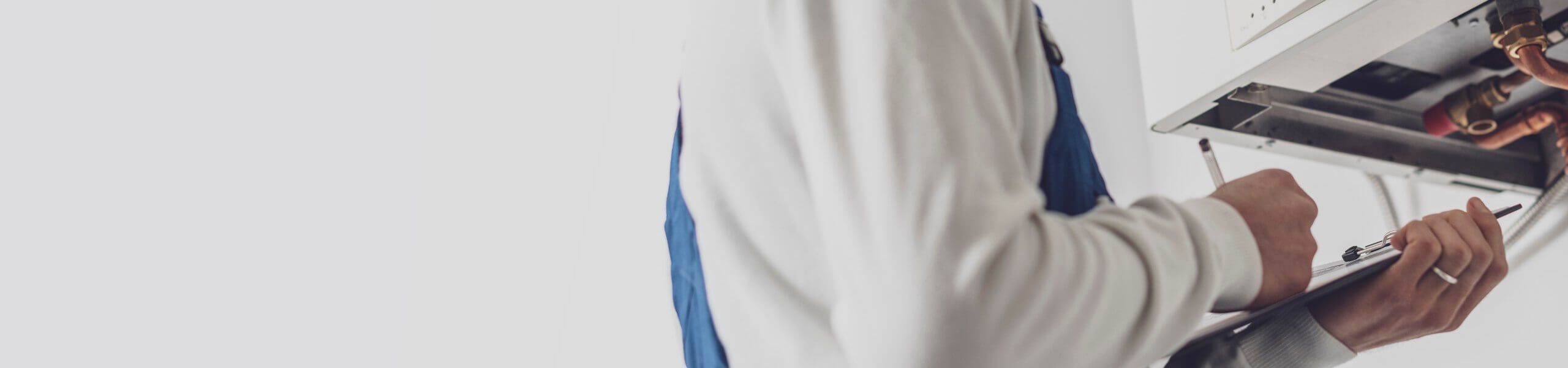 Gas fitter nanaimo Plumber fixing tap in bathroom John G. Plumbing Drain and Sewer Cleaning