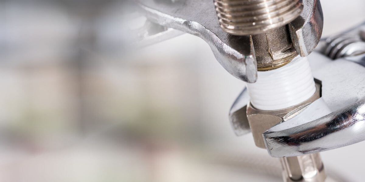 Plumber fixing tap in bathroom John G. Plumbing Drain and Sewer Cleaning