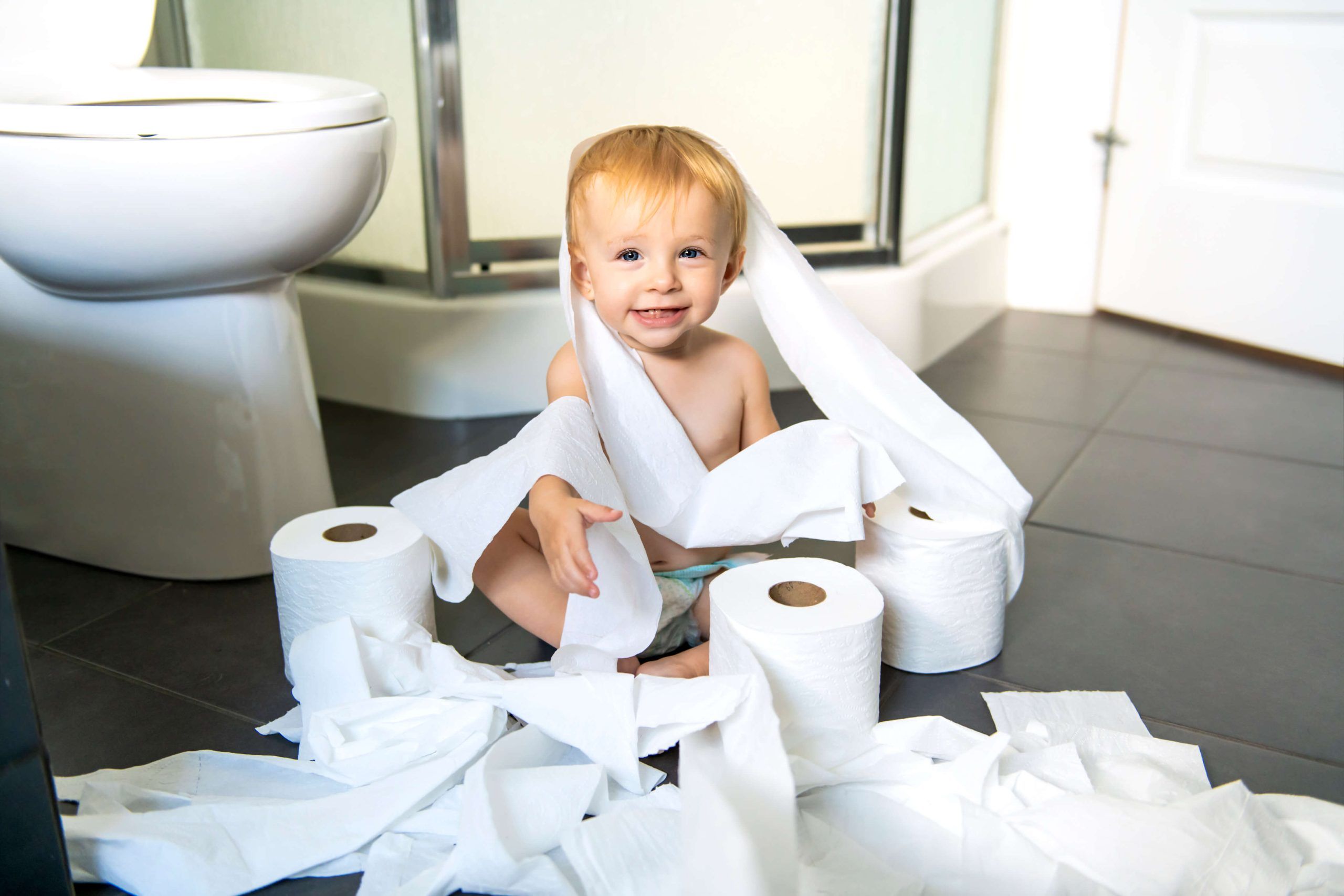 A child playing with toilet paper rolls