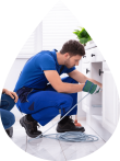 Plumber working on kitchen sink John G. Plumbing Drain and Sewer Cleaning