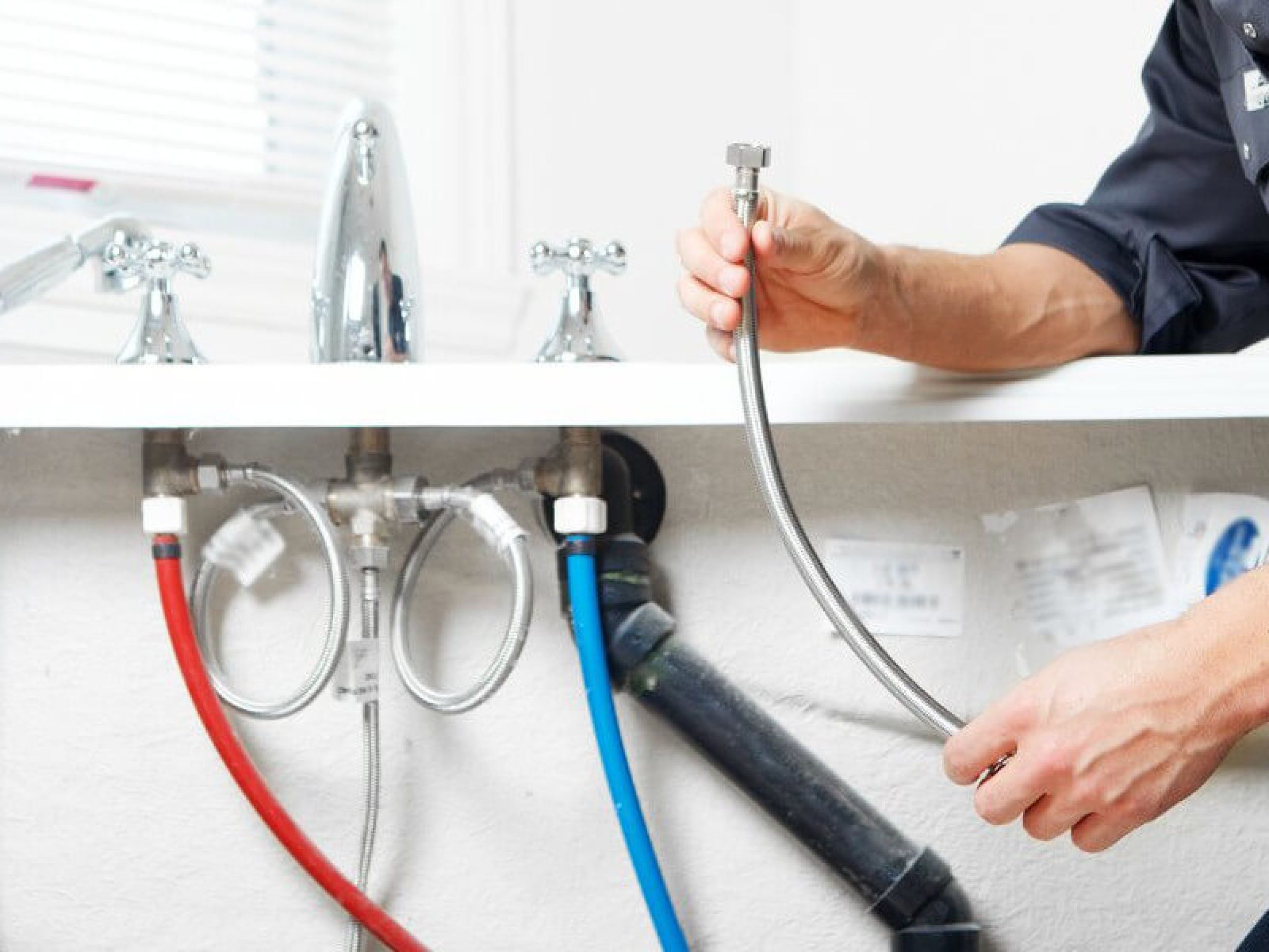 A plumber fixing a water pipes.