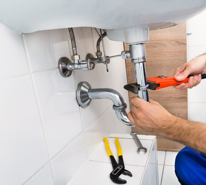 John G. Plumbing plumber fixing sink