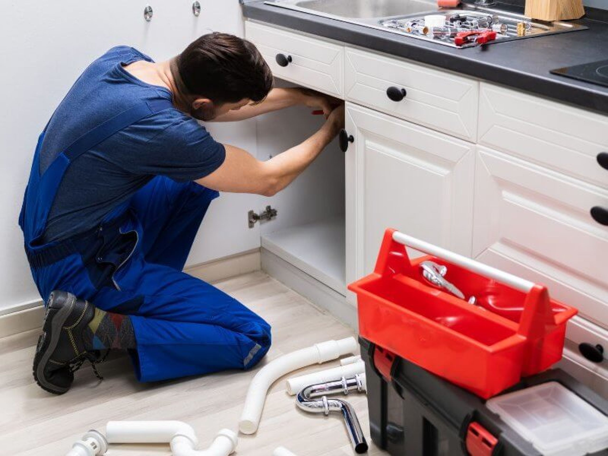 Plumber fixing pipe John G. Plumbing Drain and Sewer Cleaning