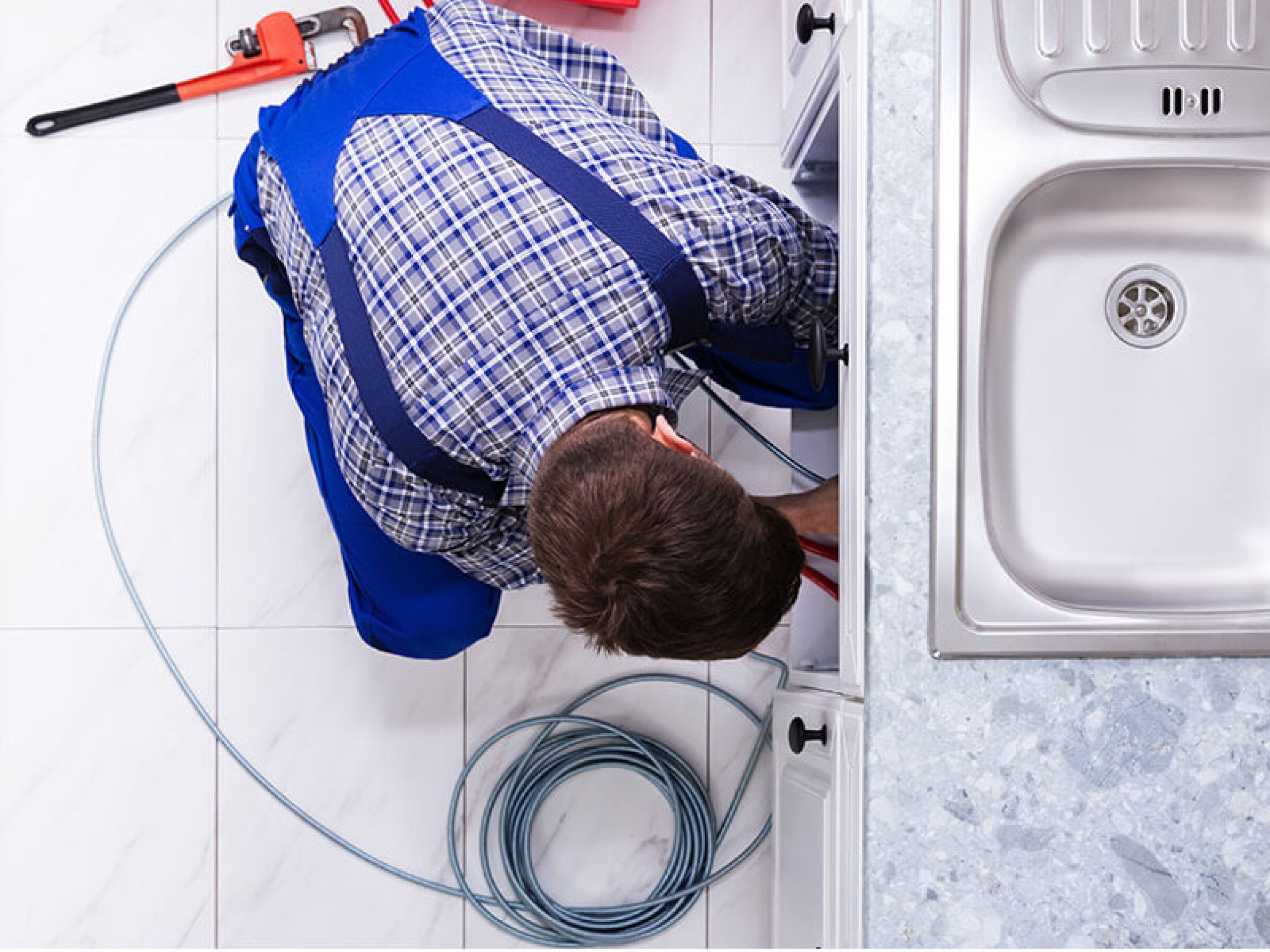 Plumber fixing pipe John G. Plumbing Drain and Sewer Cleaning