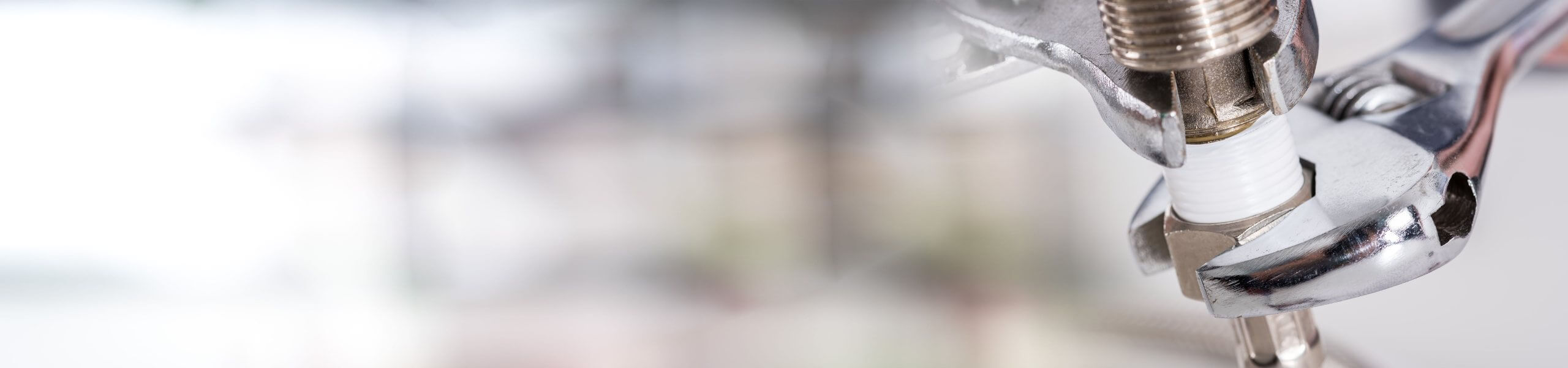 Plumber fixing tap in bathroom John G. Plumbing Drain and Sewer Cleaning