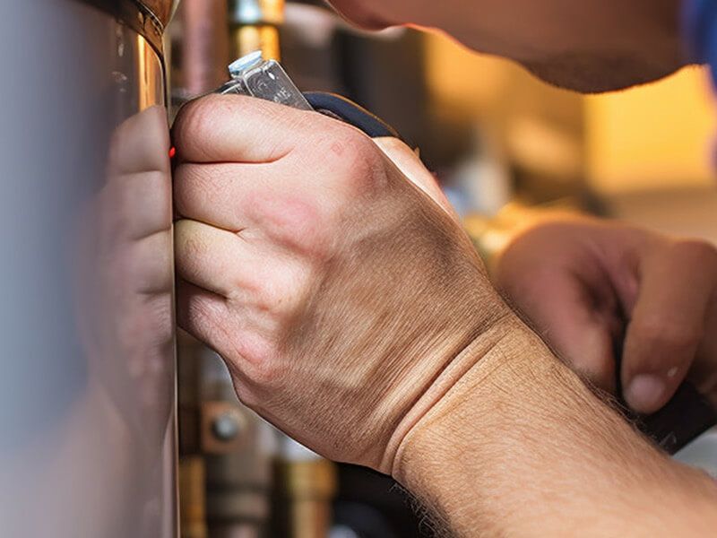 Plumber fixing pipe John G. Plumbing Drain and Sewer Cleaning