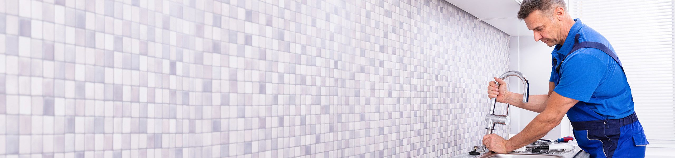 Man fixing a kitchen sink