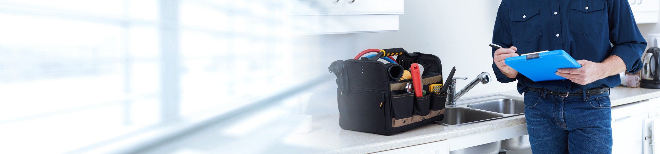 Plumber with clipboard at client's. home John G. Plumbing News