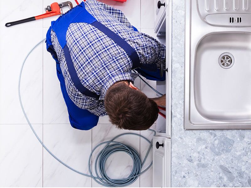Plumber fixing pipe John G. Plumbing Drain and Sewer Cleaning