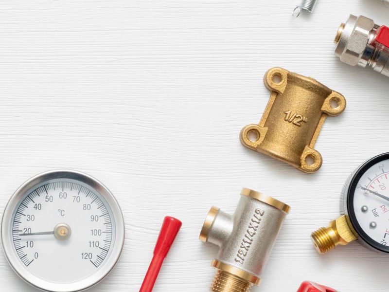 Plumber fixing tap in bathroom John G. Plumbing Drain and Sewer Cleaning