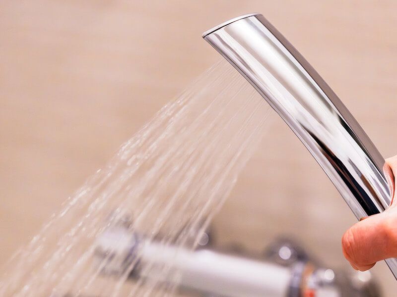 Plumber fixing tap in bathroom John G. Plumbing Drain and Sewer Cleaning