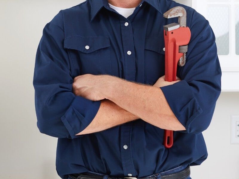 Plumber fixing tap in bathroom John G. Plumbing Drain and Sewer Cleaning