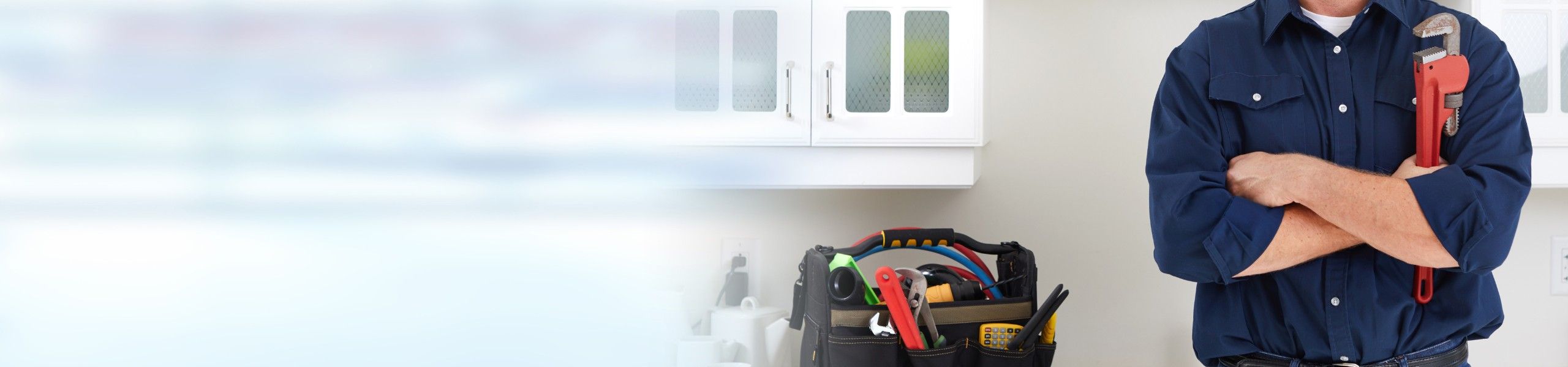 Plumber fixing tap in bathroom John G. Plumbing Drain and Sewer Cleaning