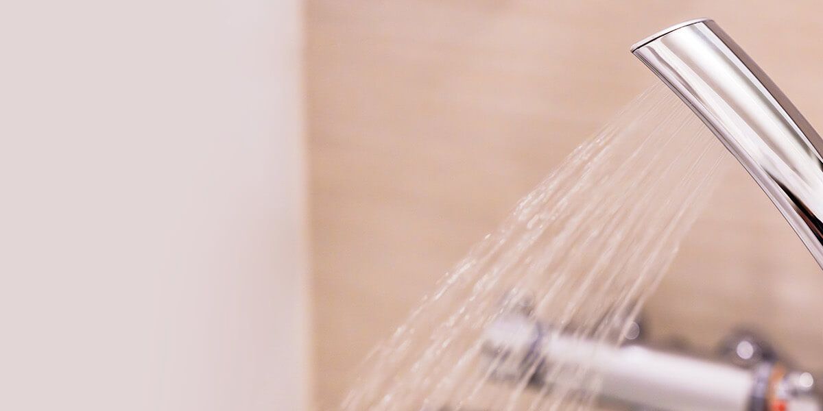 Plumber fixing tap in bathroom John G. Plumbing Drain and Sewer Cleaning