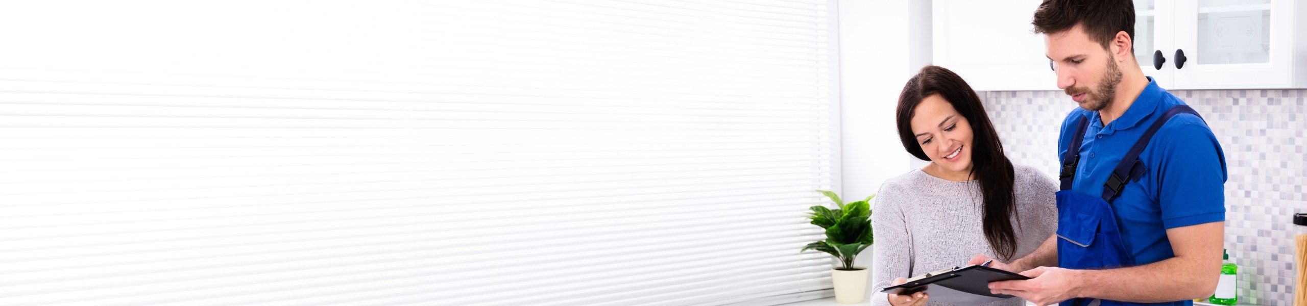 Plumber looking over notes with client John G. Plumbing Testimonials