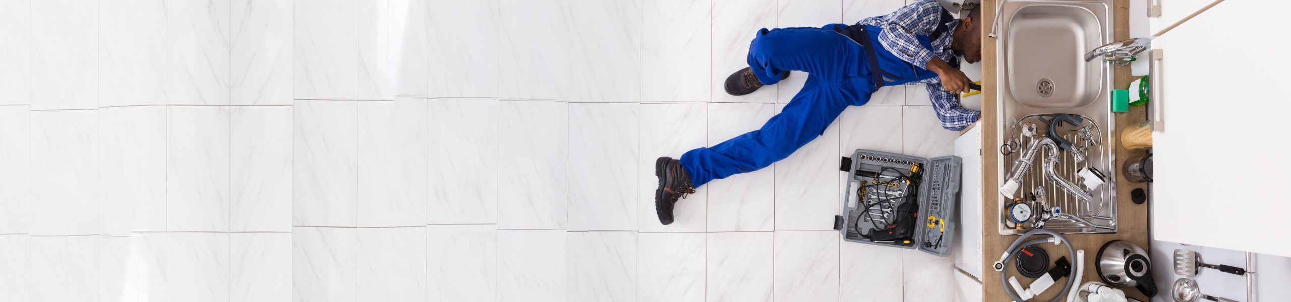 Plumber fixing sink John G. Plumbing Gas & Plumbing Coupons