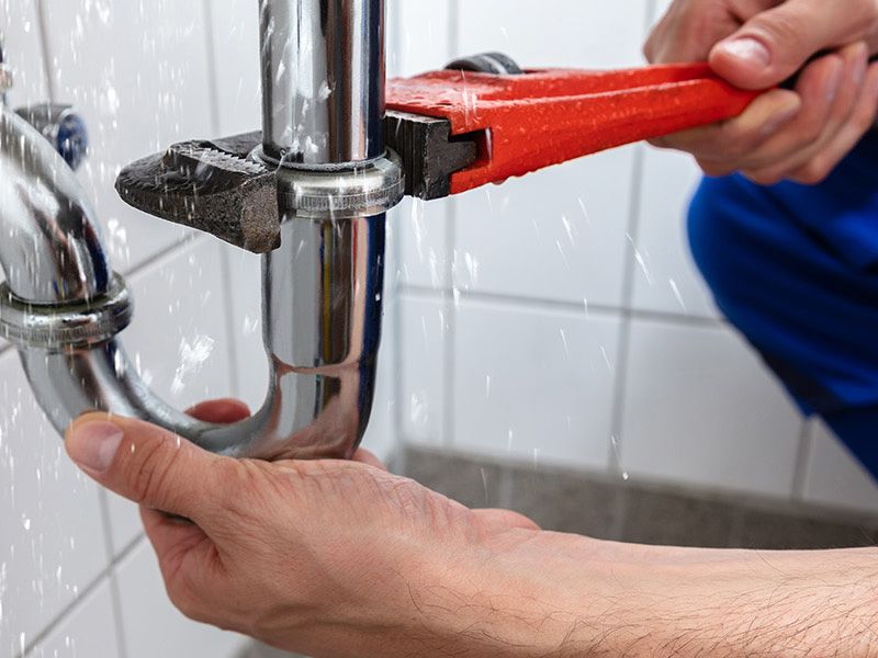 Plumber fixing pipe Contact John G. Plumbing