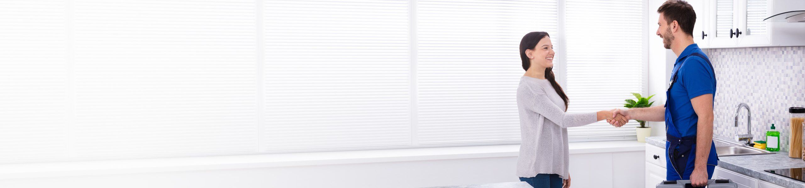 Plumber fixing tap in bathroom John G. Plumbing Drain and Sewer Cleaning