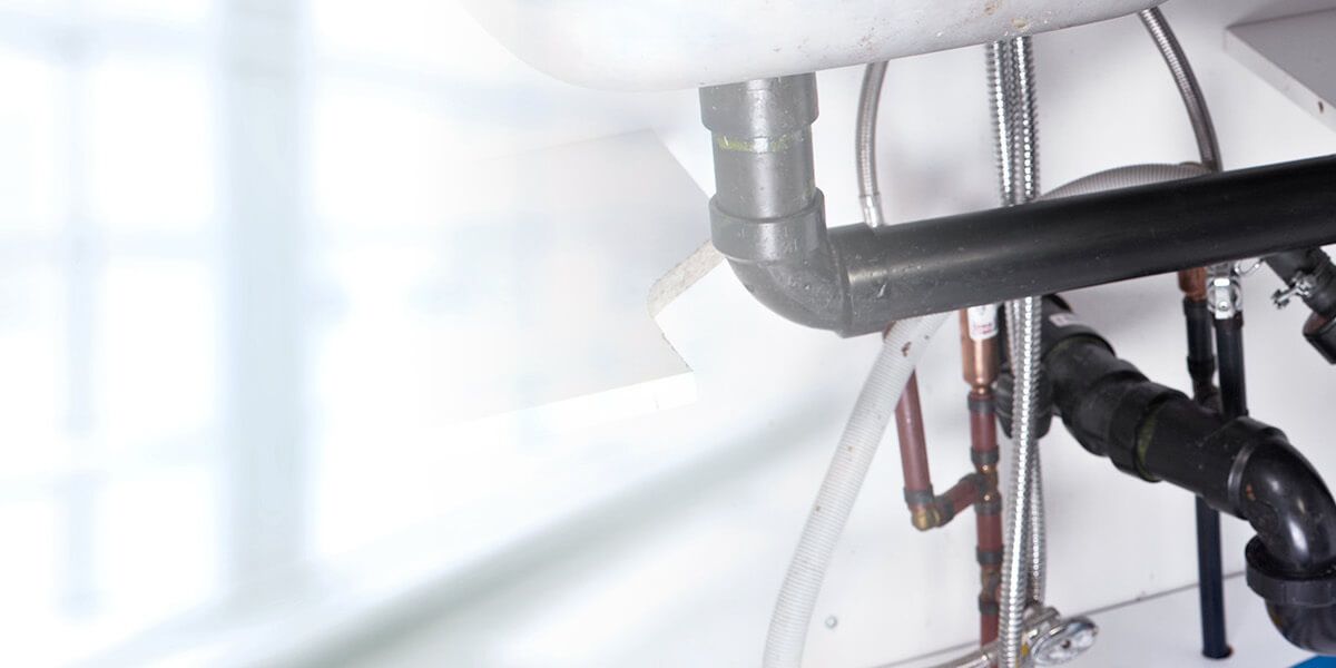 Plumber fixing pipe John G. Plumbing Drain and Sewer Cleaning