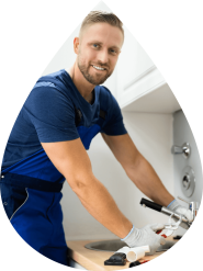 Plumber working on kitchen sink John G. Plumbing Drain and Sewer Cleaning