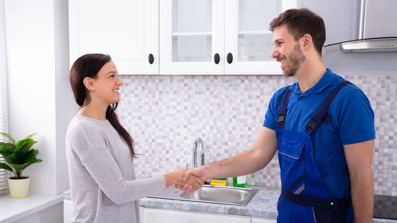 JOHN G. PLUMBING plumber shaking hands with client