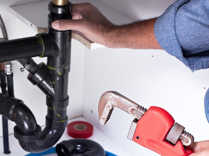 Plumber fixing pipe John G. Plumbing Drain and Sewer Cleaning