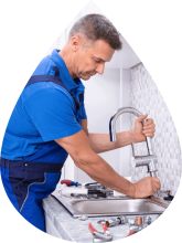 John G. Plumber working on kitchen sink for client John G. Plumbing Coombs