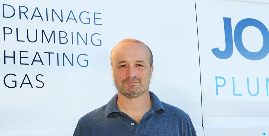 John G. Plumbing plumber shaking hands with client