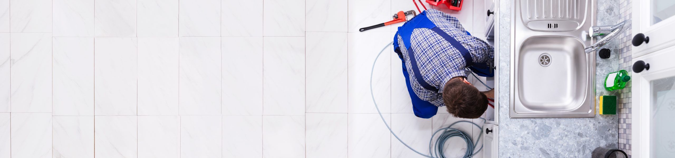 Plumber fixing sink About John G. Plumbing