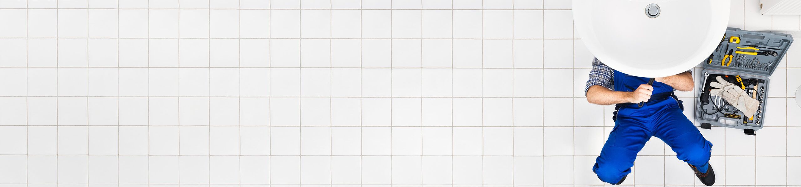 Plumber fixing tap in bathroom John G. Plumbing Drain and Sewer Cleaning