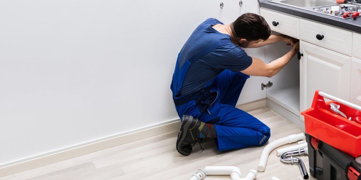 Plumber fixing pipe John G. Plumbing Drain and Sewer Cleaning