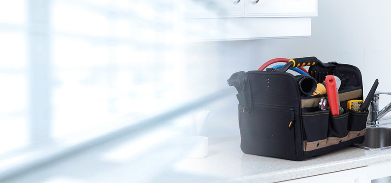 Plumber with clipboard at client's. home John G. Plumbing News